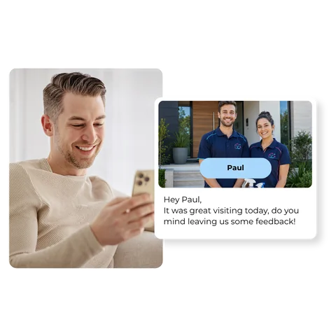 A customer smiling at his phone, reading a personalized review request: "Hey Paul, it was great visiting today, do you mind leaving us some feedback!" with a photo of the two technicians who did the job.